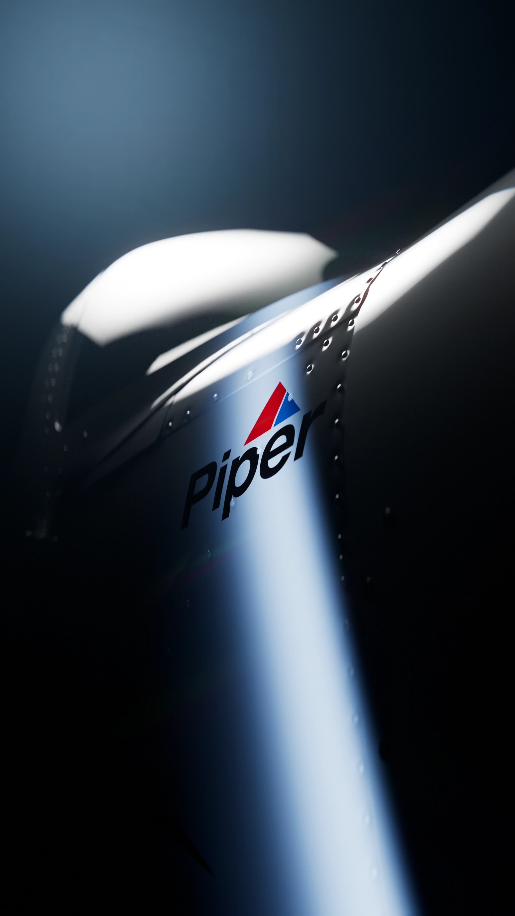 Piper Archer TX — nose badge lit by a single slash of studio light
